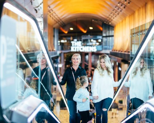 robina-town-centre-the-kitchens-mother-with-daughter-and-friend-on-escalator